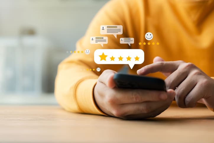 A person using a phone and leaving a review for a company