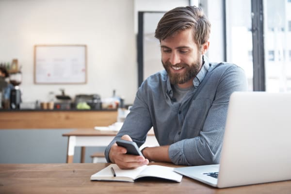 A happy customer looking at a phone