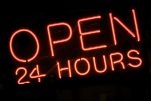 A neon sign that says Open 24 Hours
